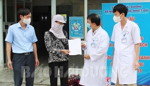 Giám đốc Bệnh viện Bệnh nhiệt đới Hải Dương Nguyễn Văn Hải trao quyết định ra viện cho bệnh nhân 2414. Ảnh: Báo Hải Dương.