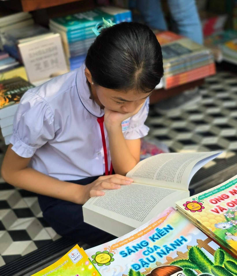 Học sinh lớp 5, Trường Tiểu học Cao Bá Quát đọc một tác phẩm văn học tại Đường Sách TPHCM.